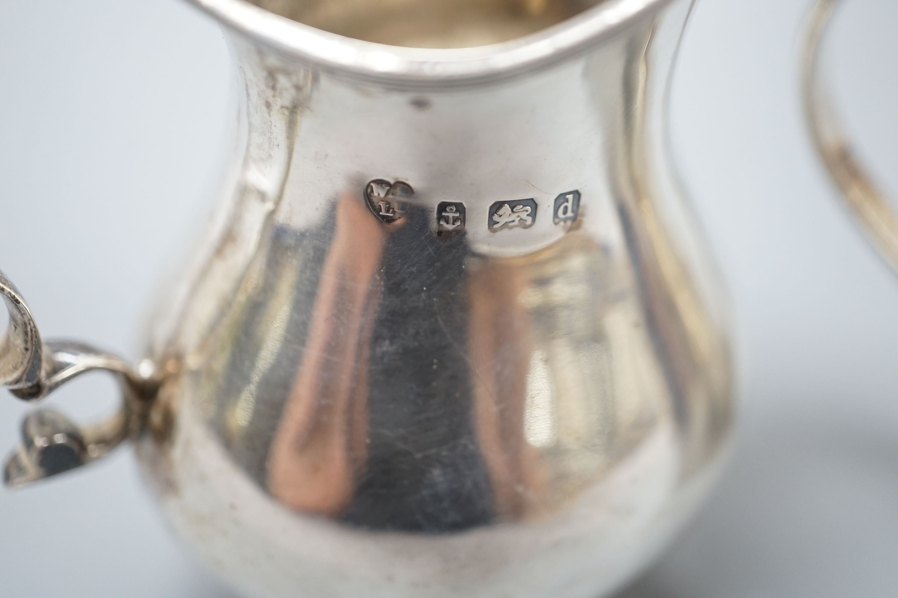 A George III engraved silver christening mug, London, 1810, 67mm and a later silver cream jug, 5oz.